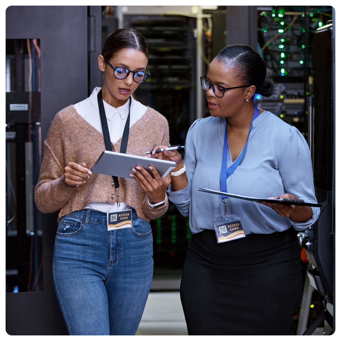 IT team reviewing campus infrastructure data on a tablet in a server room